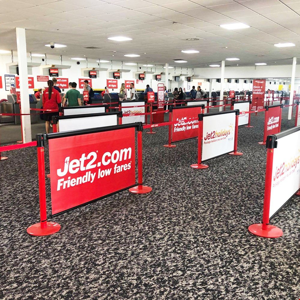 Retractable Queue Barrier RollerSigns With Retractable PVC Graphics Can be Used In conjunction With Belts To Form A long Barrier System (Belt Barrier Posts Sold Separately)